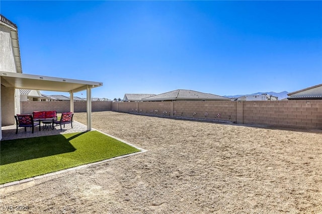 view of yard with a patio area, a fenced backyard, and an outdoor hangout area