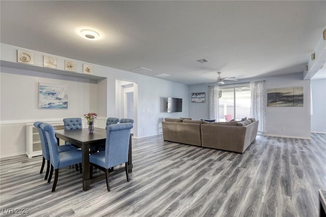 dining area featuring a ceiling fan, wood finished floors, and visible vents