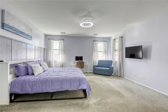 carpeted bedroom featuring visible vents and baseboards