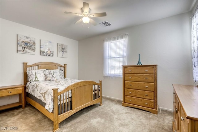 bedroom featuring visible vents, light carpet, baseboards, and ceiling fan