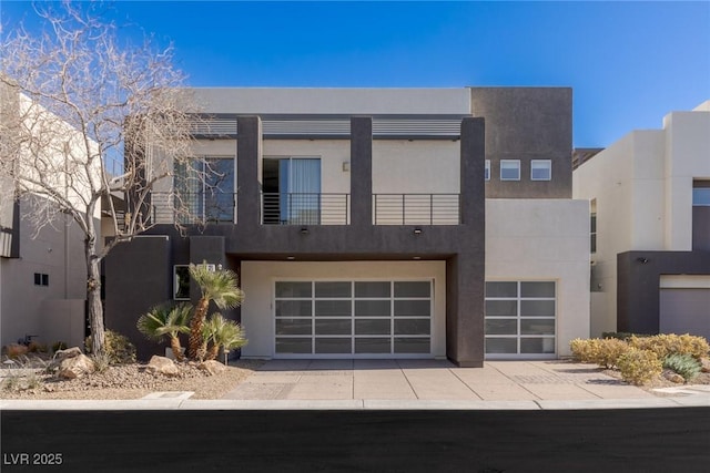 modern home featuring a garage and a balcony