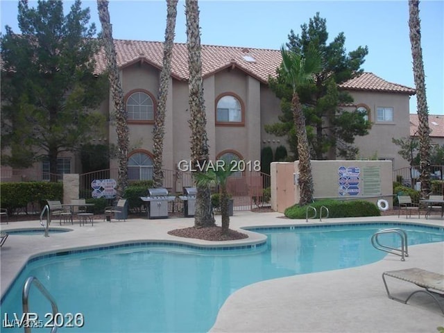 view of pool with area for grilling and a patio area