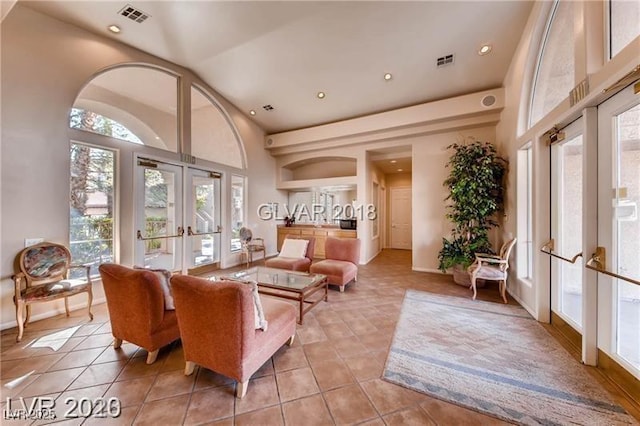 interior space featuring high vaulted ceiling and french doors