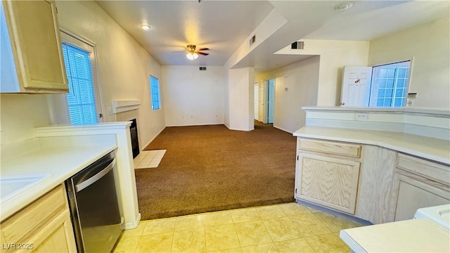 kitchen featuring light brown cabinetry, sink, light carpet, dishwasher, and ceiling fan