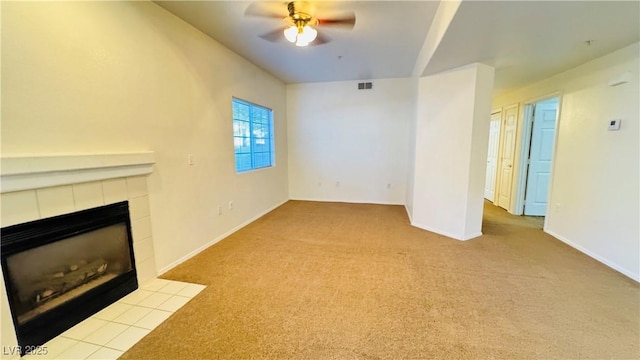 unfurnished living room featuring light carpet, a fireplace, and ceiling fan