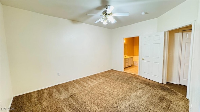 unfurnished bedroom with light carpet, ceiling fan, and ensuite bathroom