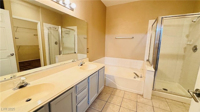 bathroom featuring tile patterned flooring, vanity, and plus walk in shower