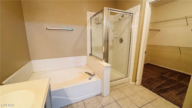 bathroom with tile patterned flooring and separate shower and tub