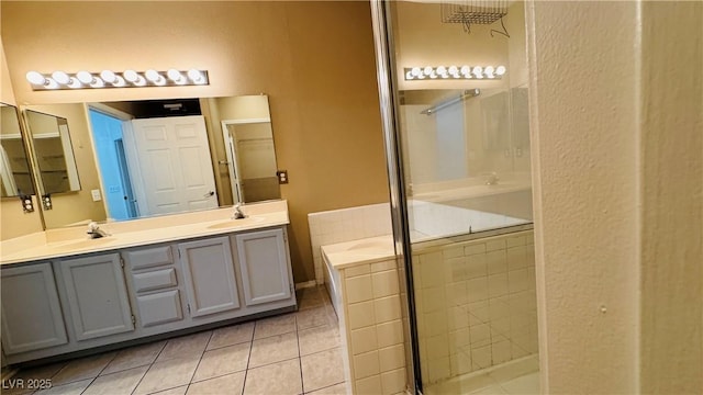 bathroom featuring vanity, shower with separate bathtub, and tile patterned floors