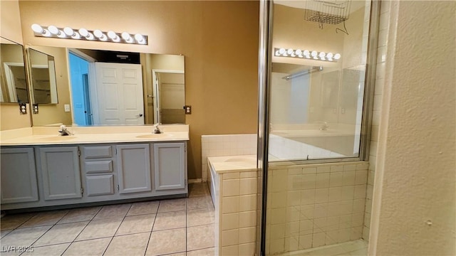 bathroom with walk in shower, vanity, and tile patterned flooring