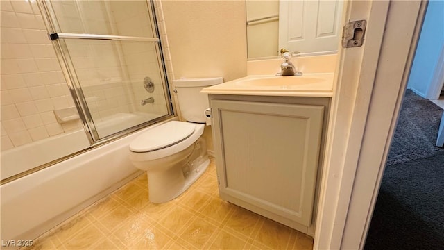 full bathroom with enclosed tub / shower combo, vanity, and toilet