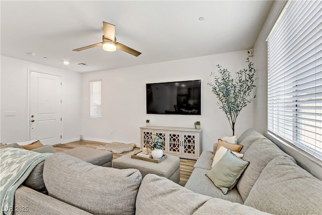 living room featuring hardwood / wood-style floors and ceiling fan