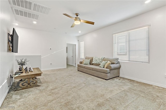 carpeted living room with a healthy amount of sunlight and ceiling fan