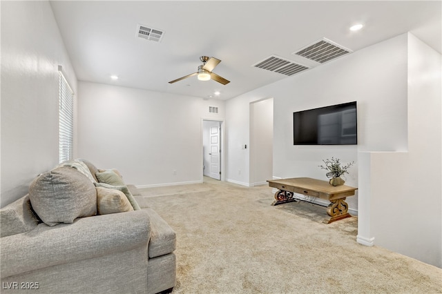 carpeted living room with ceiling fan