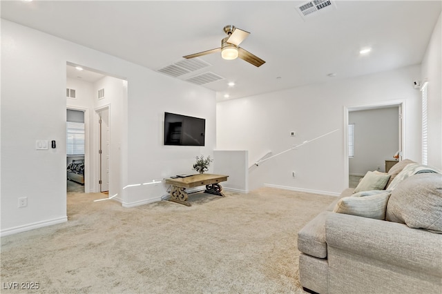 living room featuring ceiling fan and light carpet