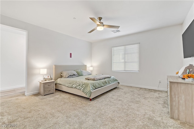 bedroom featuring light colored carpet and ceiling fan