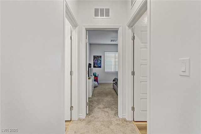 corridor with light colored carpet