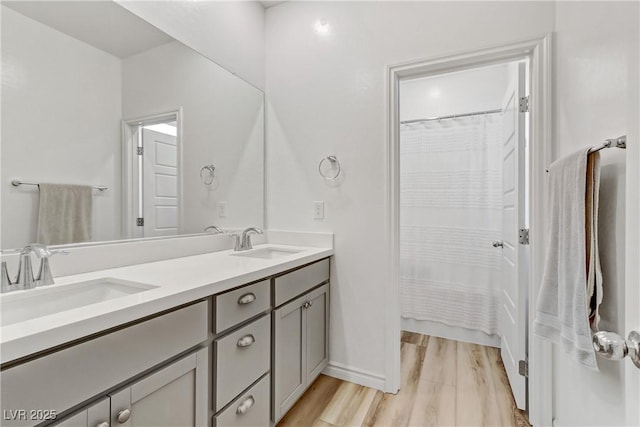 bathroom featuring vanity, hardwood / wood-style floors, and walk in shower