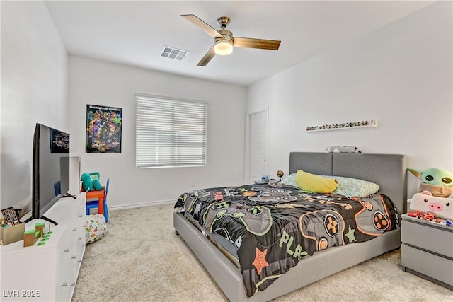 bedroom with ceiling fan and light carpet