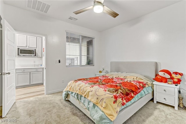 bedroom with light colored carpet and ceiling fan