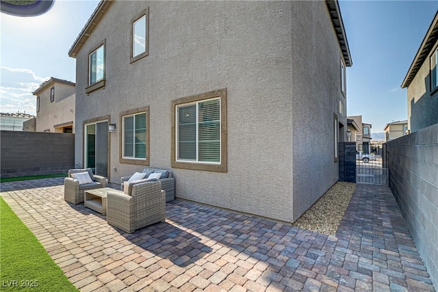 back of house featuring an outdoor hangout area and a patio