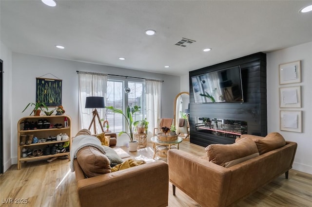 living room featuring hardwood / wood-style floors and a fireplace