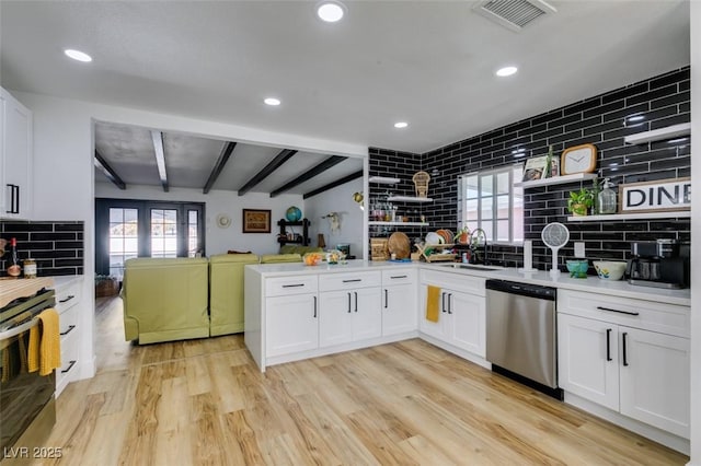 kitchen with white cabinetry, appliances with stainless steel finishes, sink, and light hardwood / wood-style floors