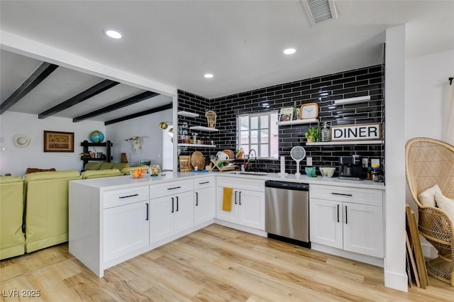 kitchen with sink, dishwasher, white cabinetry, beam ceiling, and light wood-type flooring