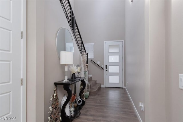 entrance foyer with baseboards, stairway, and wood finished floors