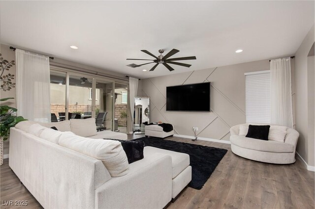 living room with ceiling fan and hardwood / wood-style floors