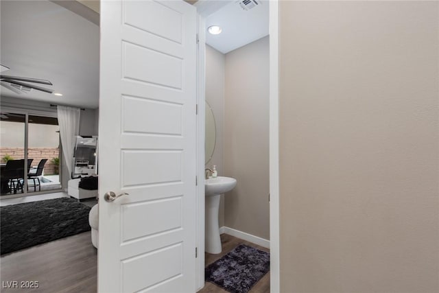 bathroom featuring visible vents, baseboards, and wood finished floors