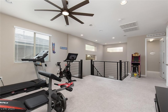 workout area featuring plenty of natural light, light colored carpet, and ceiling fan