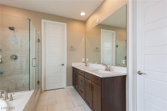 bathroom with vanity, tile patterned floors, and shower with separate bathtub