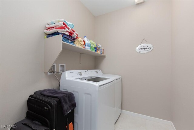 laundry room with separate washer and dryer and light tile patterned floors