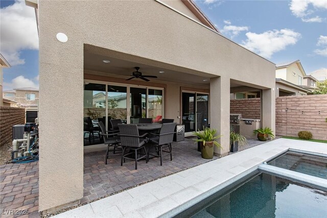 view of patio / terrace with ceiling fan, grilling area, and a fenced in pool