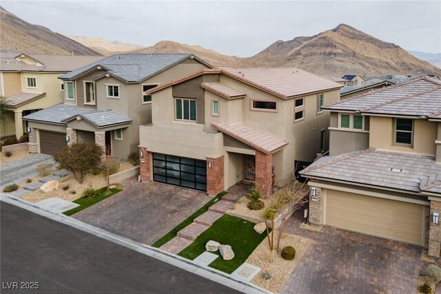 view of front facade with a mountain view and a garage