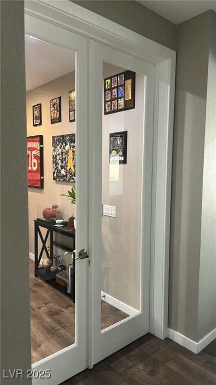 interior space with baseboards and wood finished floors