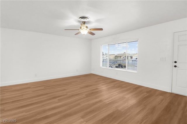 spare room with hardwood / wood-style flooring and ceiling fan