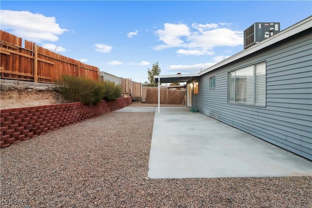 view of yard featuring central air condition unit and a patio area