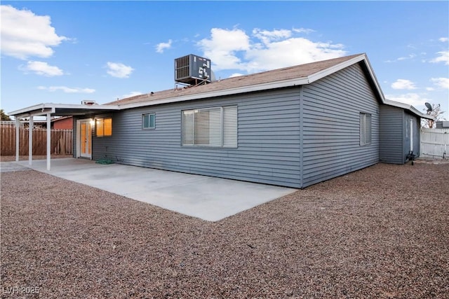 rear view of house with a patio and cooling unit