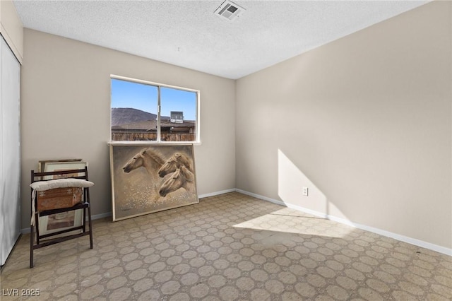 spare room featuring a textured ceiling