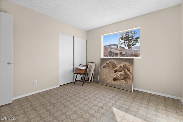 empty room featuring a textured ceiling