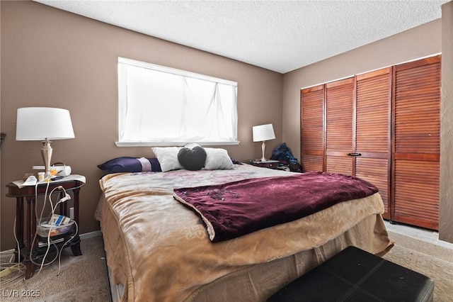 carpeted bedroom featuring a closet and a textured ceiling