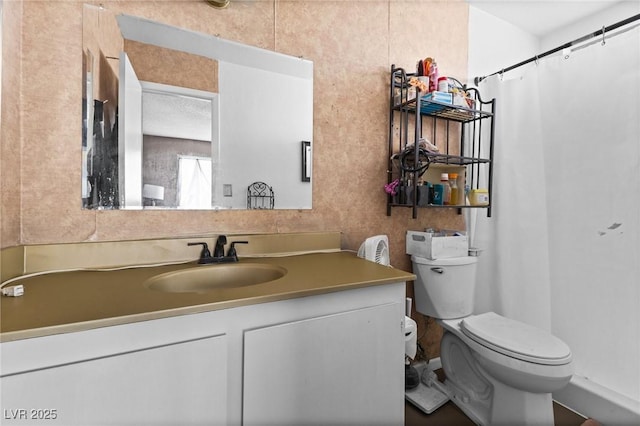 bathroom featuring a shower with curtain, vanity, and toilet