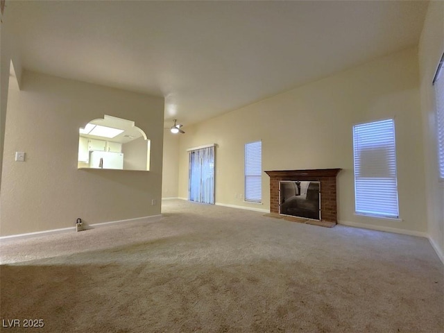 unfurnished living room with a fireplace and carpet floors