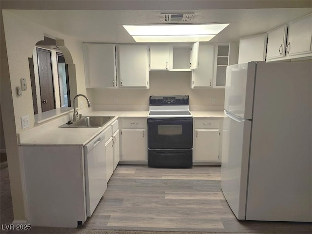 kitchen featuring white cabinetry, white appliances, and sink