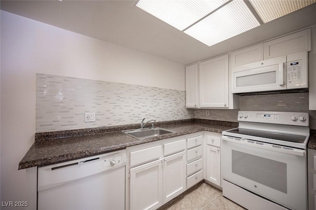 1701 E Katie Ave Unit 65, Las Vegas, NV 89119 - kitchen featuring white appliances, a sink, tasteful backsplash, white cabinetry, and dark countertops