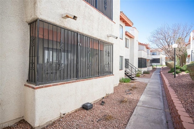 1701 E Katie Ave Unit 65, Las Vegas, NV 89119 - view of property exterior featuring stucco siding and a residential view