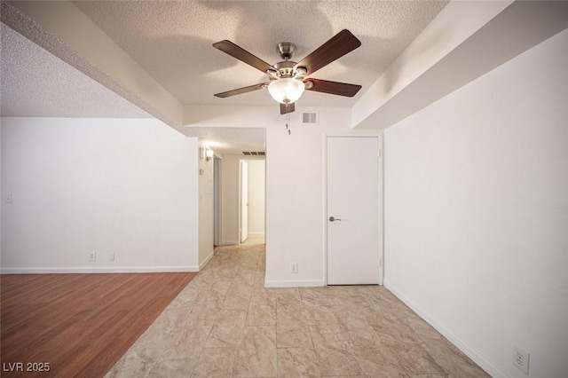 1701 E Katie Ave Unit 65, Las Vegas, NV 89119 - spare room with a textured ceiling, a ceiling fan, and baseboards