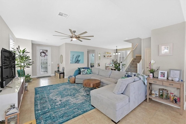 tiled living room featuring plenty of natural light and ceiling fan